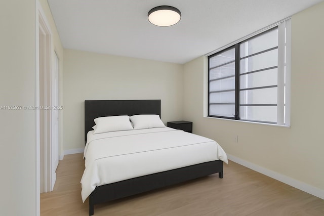 1001 Colony Point Cir Unit 419, Pembroke Pines, FL 33026 - bedroom featuring baseboards and light wood-style flooring