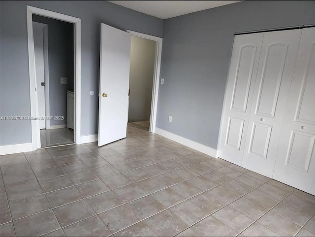 5851 W 20th Ave Unit 412, Hialeah, FL 33012 - unfurnished bedroom with tile patterned flooring and a closet