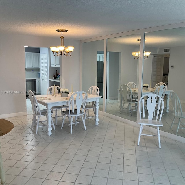 9201 Sunrise Lakes Blvd Unit 205, Sunrise, FL 33322 - dining area with a chandelier, a textured ceiling, and light tile patterned flooring