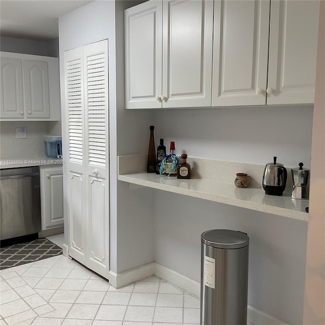 9201 Sunrise Lakes Blvd Unit 205, Sunrise, FL 33322 - kitchen with stainless steel dishwasher, white cabinetry, light countertops, and light tile patterned flooring