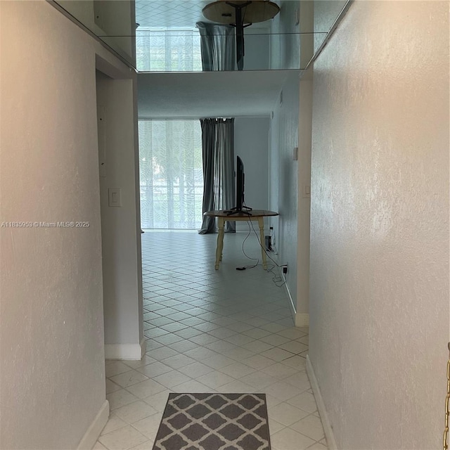9201 Sunrise Lakes Blvd Unit 205, Sunrise, FL 33322 - hallway featuring a textured wall and light tile patterned floors