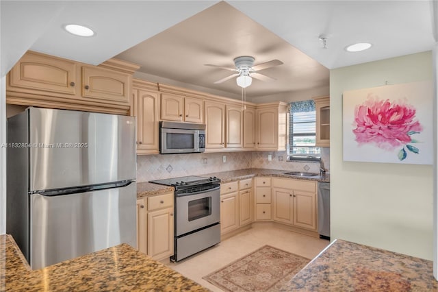 2430 Deer Creek Country Club Blvd Unit 304-2, Deerfield Beach, FL 33442 - kitchen with appliances with stainless steel finishes, a ceiling fan, decorative backsplash, and cream cabinetry