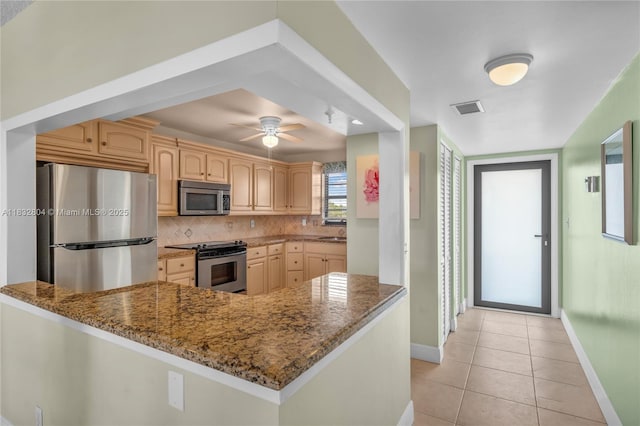 2430 Deer Creek Country Club Blvd Unit 304-2, Deerfield Beach, FL 33442 - kitchen with appliances with stainless steel finishes, dark stone countertops, tasteful backsplash, and light tile patterned floors