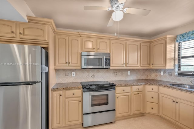 2430 Deer Creek Country Club Blvd Unit 304-2, Deerfield Beach, FL 33442 - kitchen featuring appliances with stainless steel finishes, cream cabinets, and light stone counters