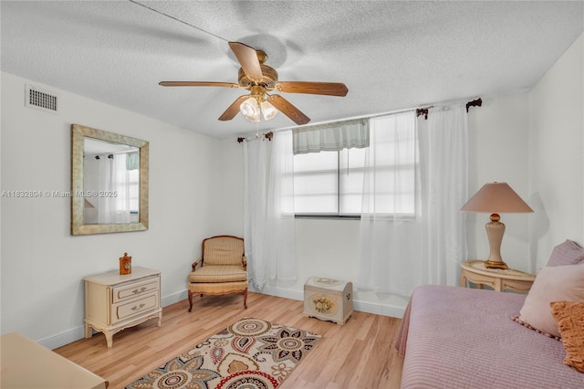 2430 Deer Creek Country Club Blvd Unit 304-2, Deerfield Beach, FL 33442 - bedroom featuring light wood-style flooring, a textured ceiling, and a ceiling fan