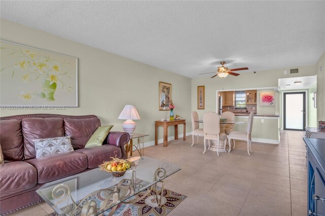 2430 Deer Creek Country Club Blvd Unit 304-2, Deerfield Beach, FL 33442 - living room with ceiling fan, a textured ceiling, and light tile patterned flooring