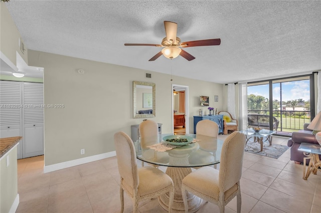 2430 Deer Creek Country Club Blvd Unit 304-2, Deerfield Beach, FL 33442 - dining room featuring a ceiling fan, a textured ceiling, and light tile patterned floors
