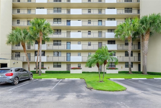 2430 Deer Creek Country Club Blvd Unit 304-2, Deerfield Beach, FL 33442 - view of apartment building / complex featuring uncovered parking