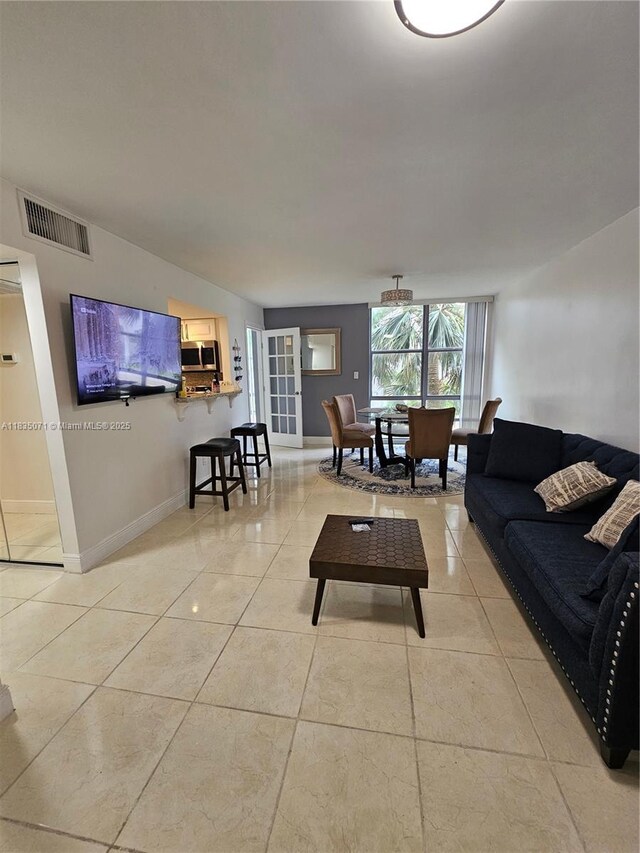 200 172nd St Unit 217, Sunny Isles Beach, FL 33160 - living room featuring light tile patterned floors and baseboards