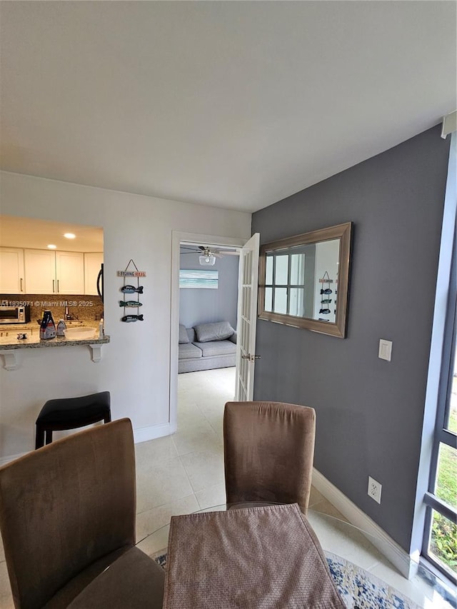 200 172nd St Unit 217, Sunny Isles Beach, FL 33160 - dining space with baseboards and light tile patterned floors