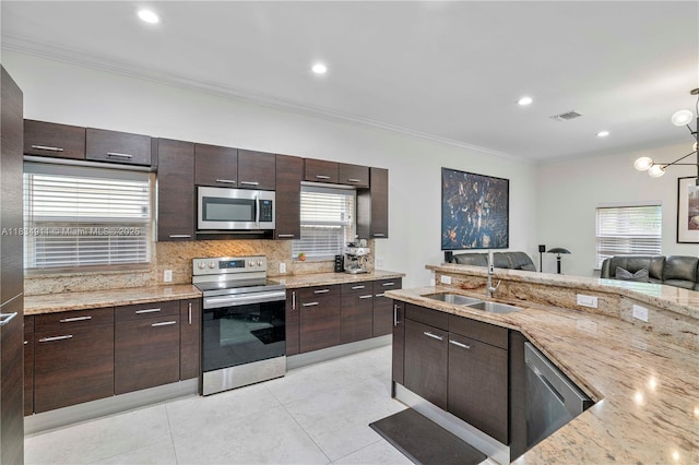 217 SW 11th St, Fort Lauderdale, FL 33315 - kitchen with stainless steel appliances, ornamental molding, decorative backsplash, dark brown cabinets, and light tile patterned floors
