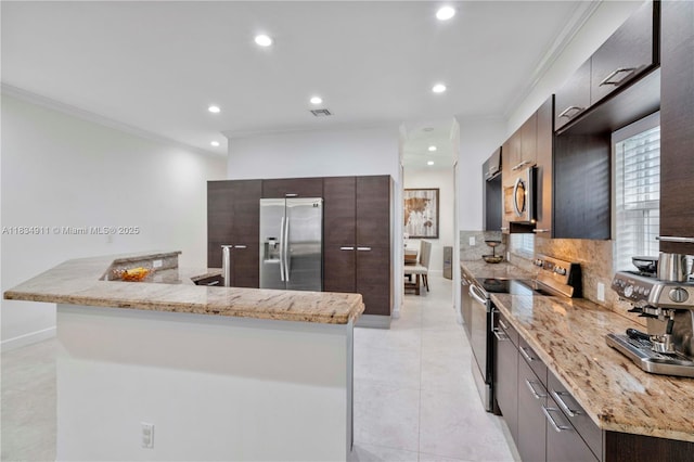 217 SW 11th St, Fort Lauderdale, FL 33315 - kitchen with appliances with stainless steel finishes, modern cabinets, recessed lighting, crown molding, and dark brown cabinets