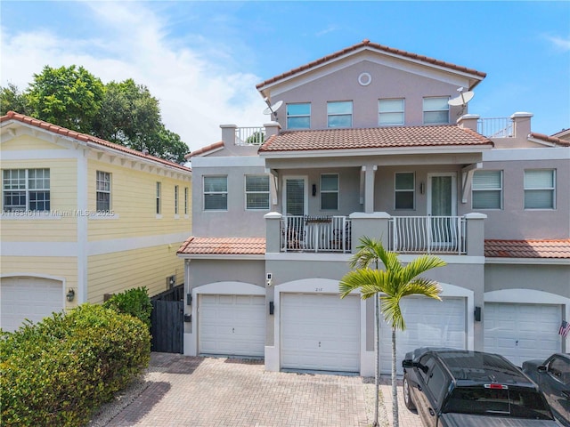 217 SW 11th St, Fort Lauderdale, FL 33315 - view of front of house with a tile roof, a garage, and stucco siding
