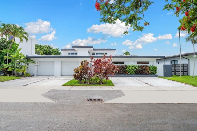 1930 NE 193rd St, Miami, FL 33179 - view of front of house with driveway, stucco siding, and an attached garage