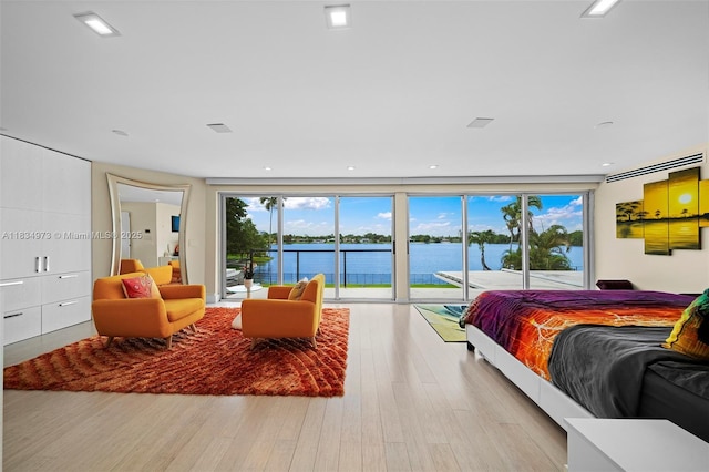 1930 NE 193rd St, Miami, FL 33179 - bedroom featuring access to exterior, wood finished floors, and a water view