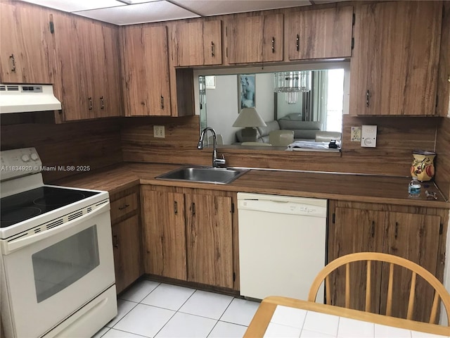 1101 Colony Point Cir Unit 206, Pembroke Pines, FL 33026 - kitchen with white appliances, under cabinet range hood, and brown cabinetry