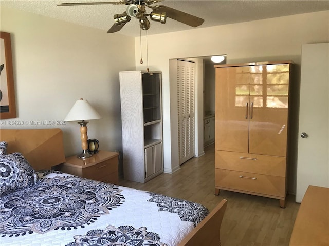 1101 Colony Point Cir Unit 206, Pembroke Pines, FL 33026 - bedroom with wood finished floors, a ceiling fan, a textured ceiling, and a closet