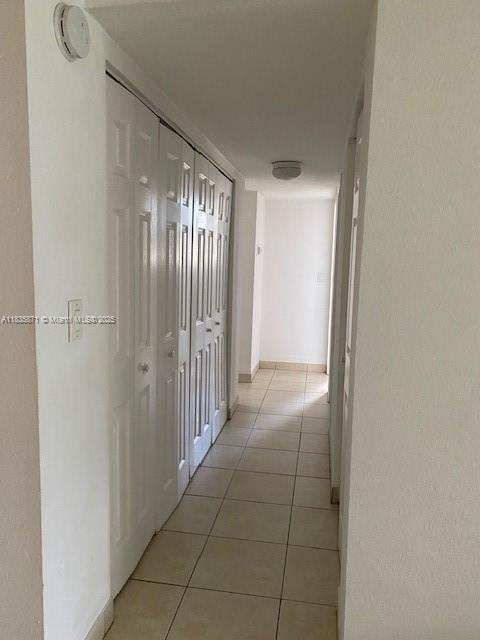 14150 SW 84th St Unit 201-I, Miami, FL 33183 - corridor with light tile patterned flooring and baseboards