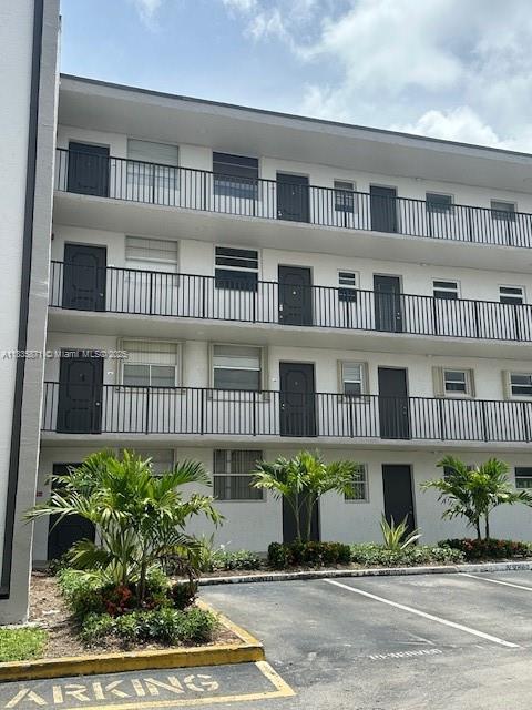 14150 SW 84th St Unit 201-I, Miami, FL 33183 - view of property featuring uncovered parking