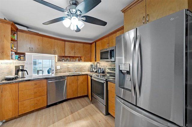 1660 NE 191st St Unit 206-1, Miami, FL 33179 - kitchen featuring stainless steel appliances, open shelves, light wood-style floors, decorative backsplash, and a ceiling fan