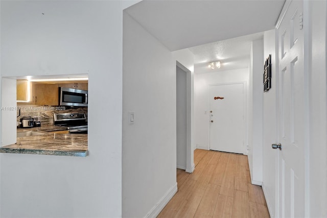 1660 NE 191st St Unit 206-1, Miami, FL 33179 - hall featuring light wood finished floors and baseboards