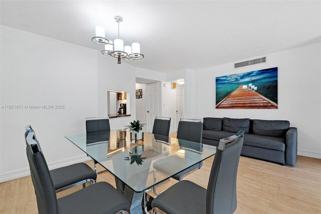 1660 NE 191st St Unit 206-1, Miami, FL 33179 - dining space with light wood-style floors and a chandelier