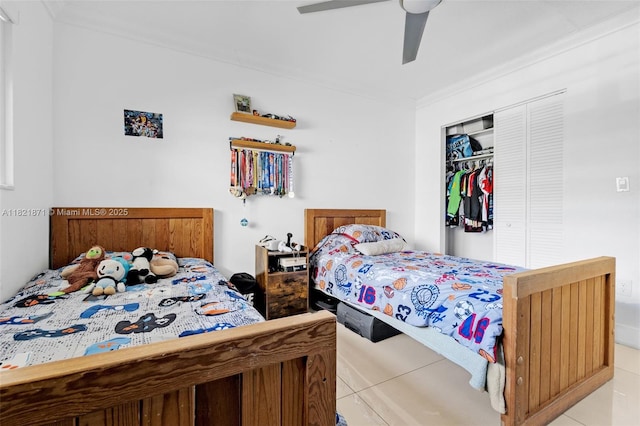 1660 NE 191st St Unit 206-1, Miami, FL 33179 - bedroom with crown molding, light tile patterned flooring, a closet, and a ceiling fan