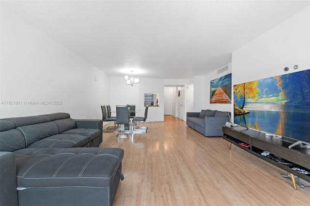 1660 NE 191st St Unit 206-1, Miami, FL 33179 - living room with a chandelier and light wood-style floors