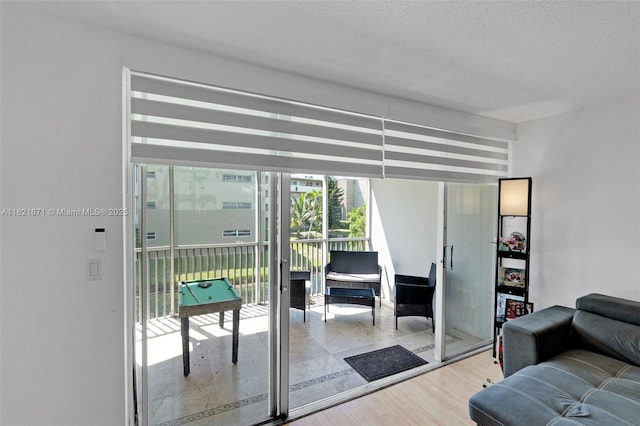 1660 NE 191st St Unit 206-1, Miami, FL 33179 - living area featuring wood finished floors and a textured ceiling