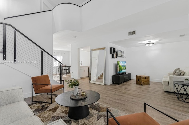 11532 SW 148th Path, Miami, FL 33196 - living area featuring stairway, light wood-style floors, and a high ceiling