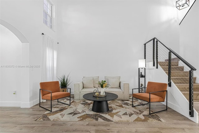 11532 SW 148th Path, Miami, FL 33196 - sitting room featuring a towering ceiling, arched walkways, wood finished floors, and stairs