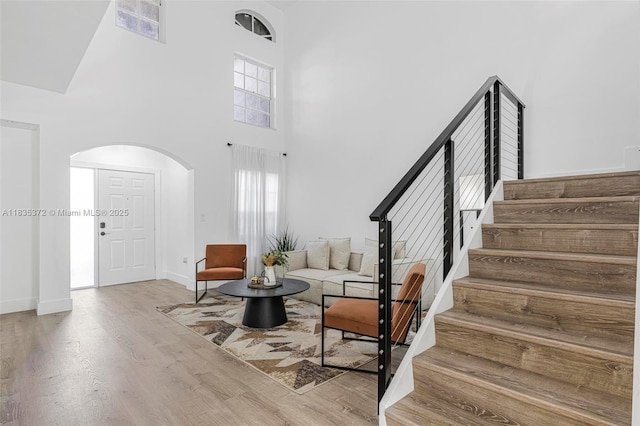 11532 SW 148th Path, Miami, FL 33196 - entryway featuring arched walkways, stairway, wood finished floors, plenty of natural light, and a towering ceiling