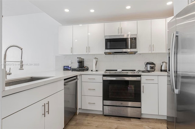 11532 SW 148th Path, Miami, FL 33196 - kitchen featuring appliances with stainless steel finishes, white cabinetry, light countertops, tasteful backsplash, and recessed lighting