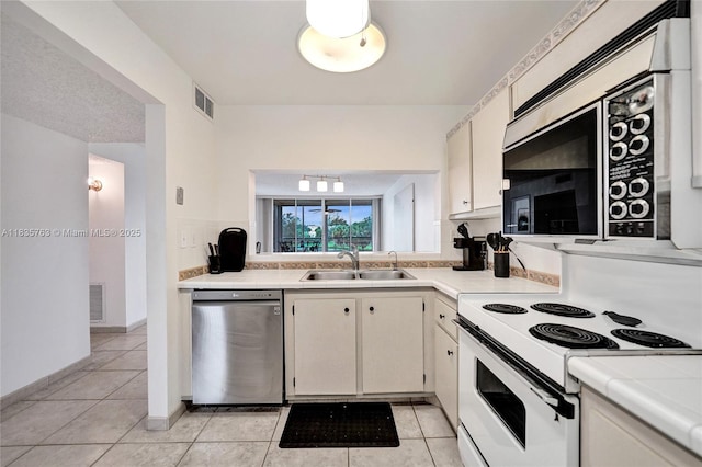 1911 Sabal Palm Dr Unit 304, Davie, FL 33324 - kitchen featuring appliances with stainless steel finishes, light tile patterned flooring, and tile counters