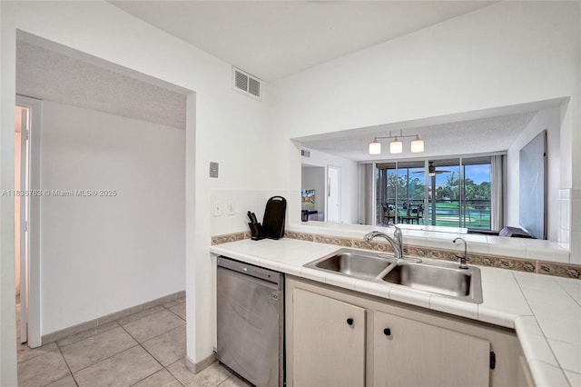 1911 Sabal Palm Dr Unit 304, Davie, FL 33324 - kitchen featuring dishwasher, tile counters, light tile patterned floors, and decorative backsplash