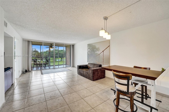 1911 Sabal Palm Dr Unit 304, Davie, FL 33324 - dining room featuring a textured ceiling, floor to ceiling windows, light tile patterned floors, and a ceiling fan