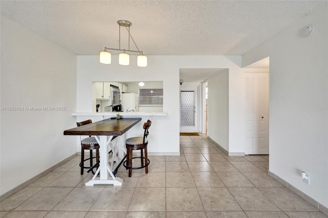 1911 Sabal Palm Dr Unit 304, Davie, FL 33324 - dining room featuring a textured ceiling and light tile patterned floors