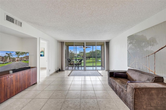 1911 Sabal Palm Dr Unit 304, Davie, FL 33324 - unfurnished living room with expansive windows, a textured ceiling, and light tile patterned floors