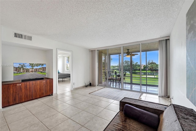 1911 Sabal Palm Dr Unit 304, Davie, FL 33324 - living area featuring expansive windows, light tile patterned floors, a ceiling fan, and a textured ceiling