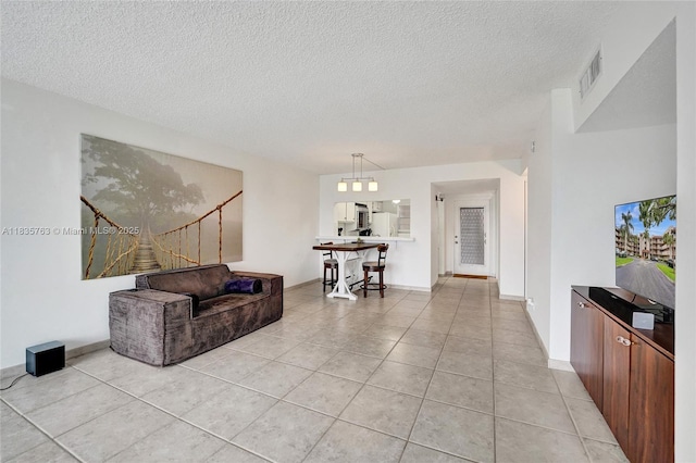 1911 Sabal Palm Dr Unit 304, Davie, FL 33324 - living room featuring a textured ceiling, light tile patterned floors, and stairs