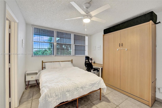 1911 Sabal Palm Dr Unit 304, Davie, FL 33324 - bedroom featuring a textured ceiling, light tile patterned floors, and ceiling fan