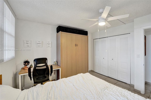 1911 Sabal Palm Dr Unit 304, Davie, FL 33324 - tiled bedroom with a closet, a ceiling fan, and a textured ceiling