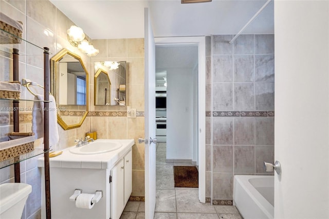 1911 Sabal Palm Dr Unit 304, Davie, FL 33324 - full bath featuring tile walls, tile patterned floors, vanity, and bathing tub / shower combination