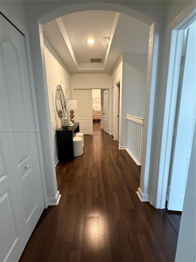 14902 SW 23rd Way, Miami, FL 33185 - hall featuring arched walkways, a tray ceiling, and dark wood-type flooring