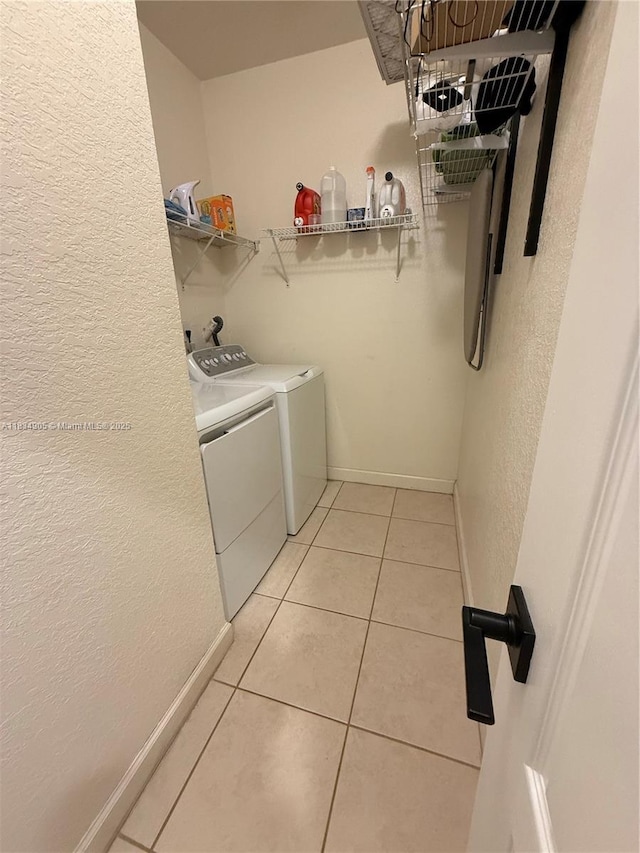 14902 SW 23rd Way, Miami, FL 33185 - laundry room with separate washer and dryer, a textured wall, and light tile patterned flooring