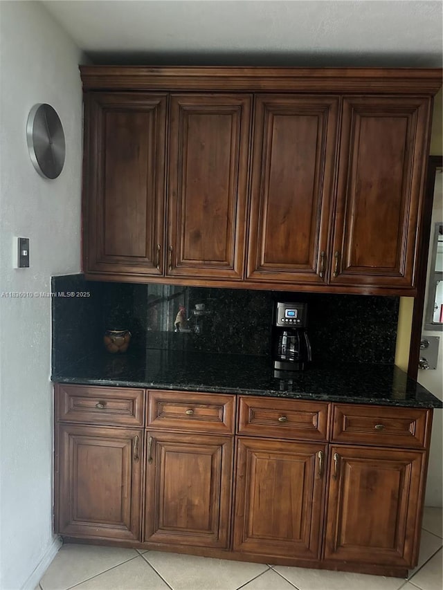 9260 SW 176th St, Palmetto Bay, FL 33157 - kitchen featuring dark stone countertops, light tile patterned floors, and tasteful backsplash