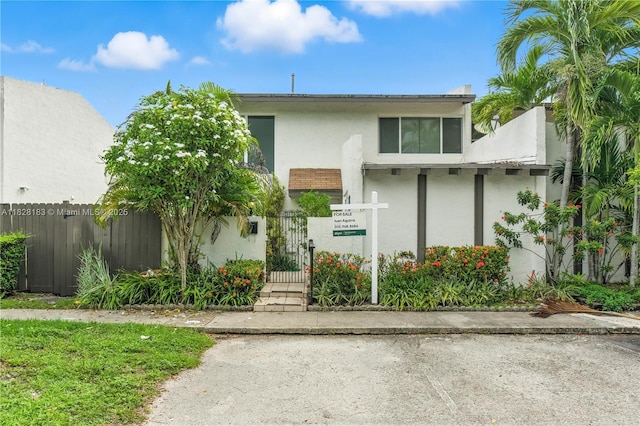 11245 SW 65th St, Miami, FL 33173 - view of front of house with a fenced front yard, a gate, and stucco siding