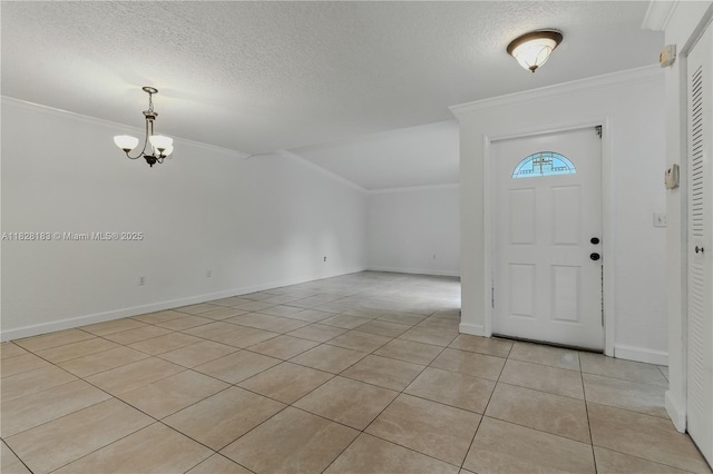 11245 SW 65th St, Miami, FL 33173 - foyer entrance featuring ornamental molding, light tile patterned flooring, a textured ceiling, a chandelier, and vaulted ceiling