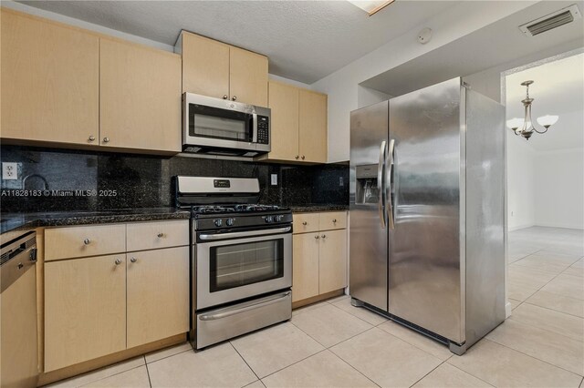 11245 SW 65th St, Miami, FL 33173 - kitchen with appliances with stainless steel finishes, light brown cabinetry, backsplash, a chandelier, and light tile patterned floors