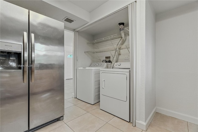 11245 SW 65th St, Miami, FL 33173 - laundry area with independent washer and dryer and light tile patterned floors